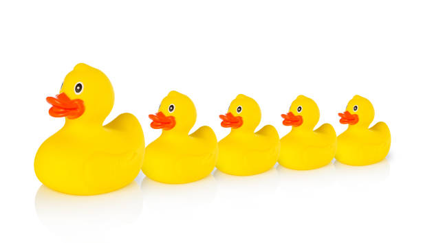 istock Mother rubber duck leading several rubber ducklings 477268532