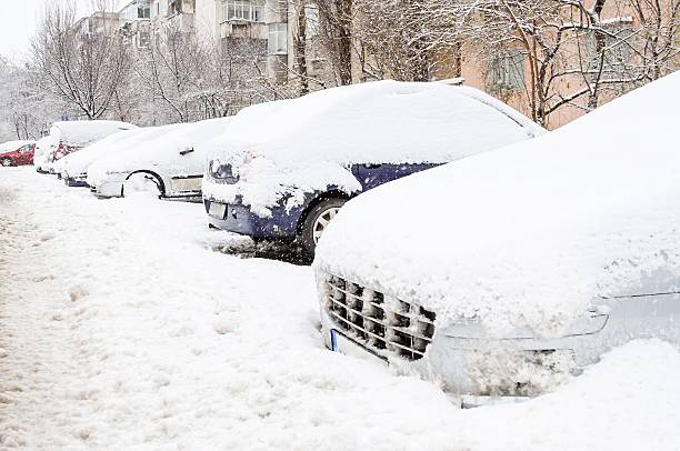 istock Cars covered with snow after a storm 477276384