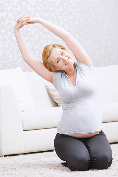 istock Pregnant woman doing exersices 477279434
