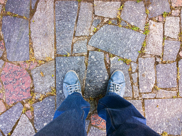 istock Feet on the paving stone. 477281626