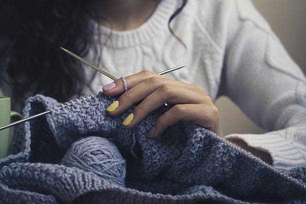 istock Blue knitting in female hands closeup 477282540