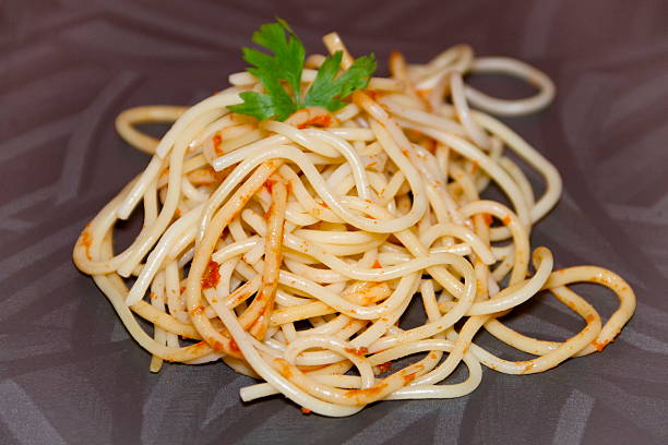 spaghetti con prezzemolo fresco cotto - teigwaren foto e immagini stock