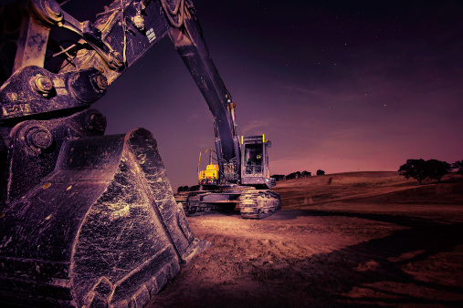 A large excavator at night