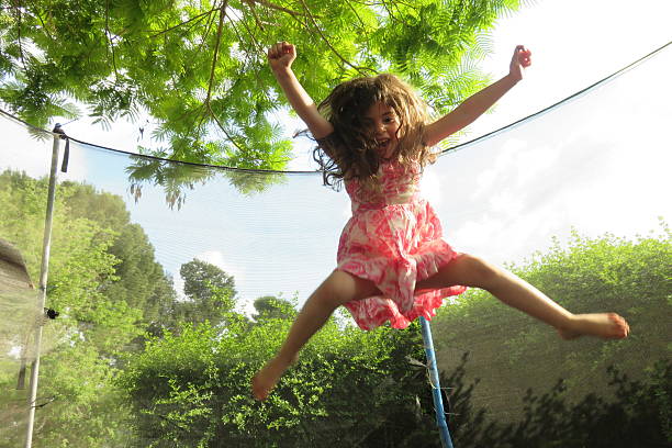 Girl playing on the trampoline