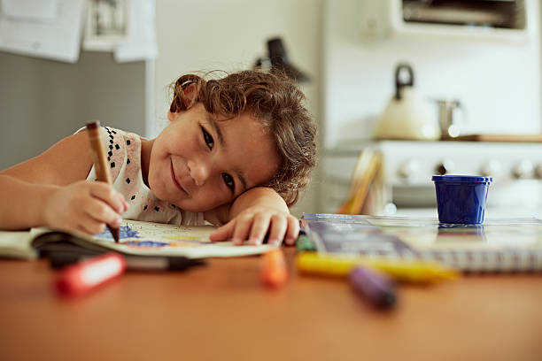 Portrait of little girl drawing stock photo