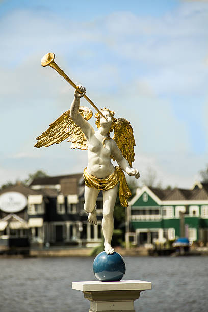 Statue of an winged angel playing the victory with its trumper, Monza, Italy