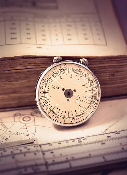 Rare mechanical slide-rule with old book and schemes
