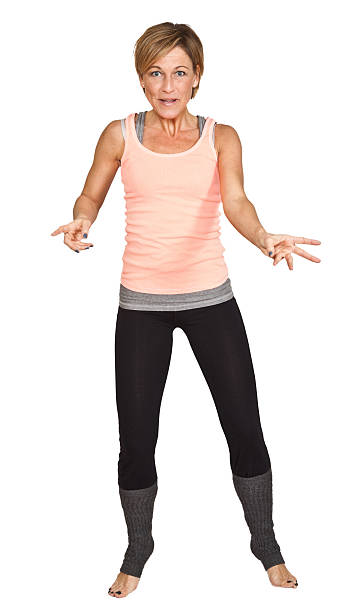 istock Cute woman standing and dancing on isolated white background 477328617