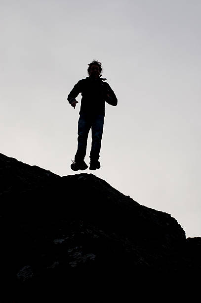 istock Black silhouette of a boy jumping 477328875
