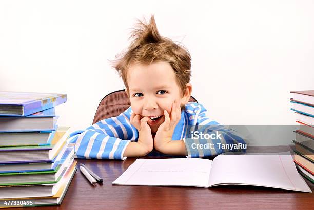 Cute Boy Laughing Sitting At The Desk Stock Photo - Download Image Now - Boys, 4-5 Years, Book
