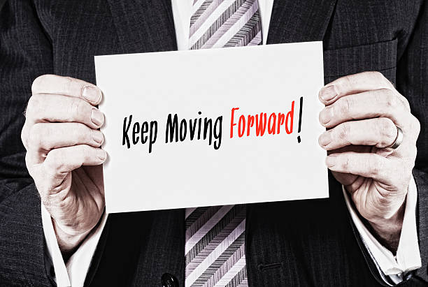 istock Businessman holding a card with the words, Keep Moving Forwar 477334342