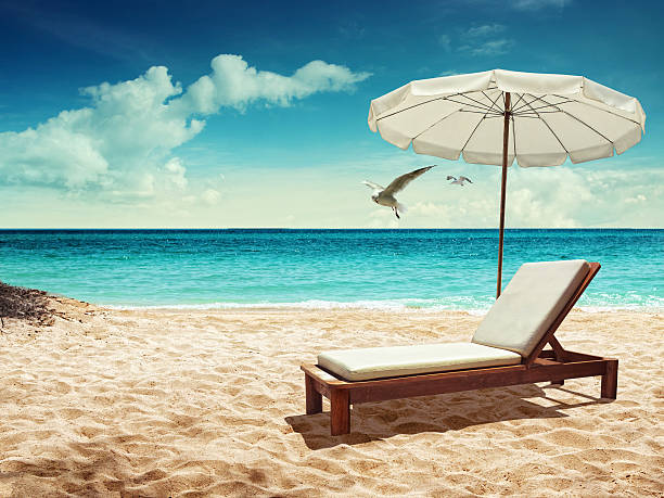 Beach chair and the umbrella on sand beach. Concept for rest 
