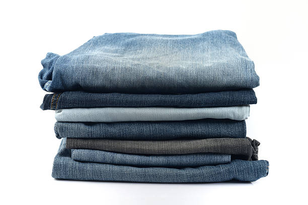 istock Stack of  Blue and Black Jeans on White Background. 477334626