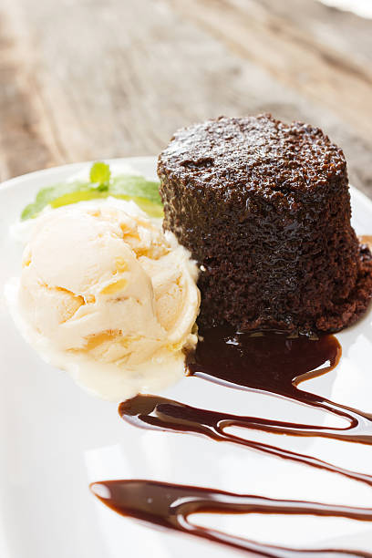 istock Chocolate cake with rum raisin ice cream and whipping cream. 477335154