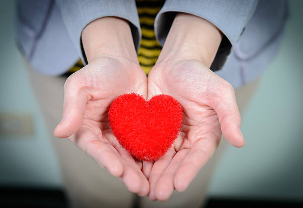 istock Red heart in woman hands 477337518