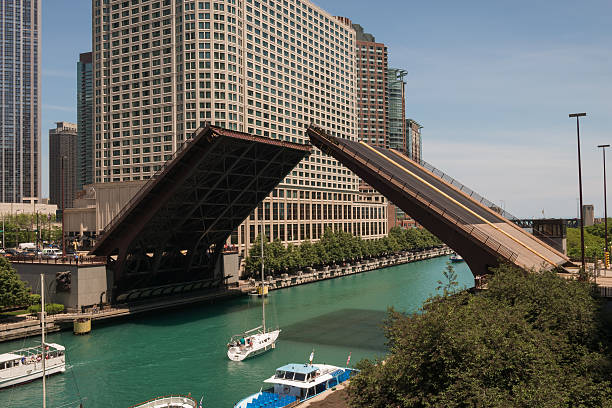William P. Fahey Bridge Сhicago, USA - June 3, 2015: The William P Fahey bridge on Michigan avenue going up on the Chicago Riverwalk for the boat run mid day. opening bridge stock pictures, royalty-free photos & images