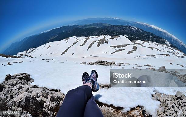 Legs Of Traveler Sitting On High Mountain Top In Turkey Stock Photo - Download Image Now