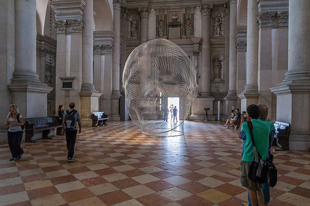 Spectators admire artwork by Jaume Plensa at the Venice Biennale stock photo