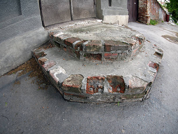 istock Older steps near an old house 477340414