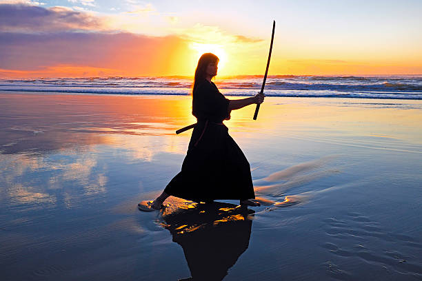 istock Young samurai women with Japanese sword(Katana) at sunset on the 477340503