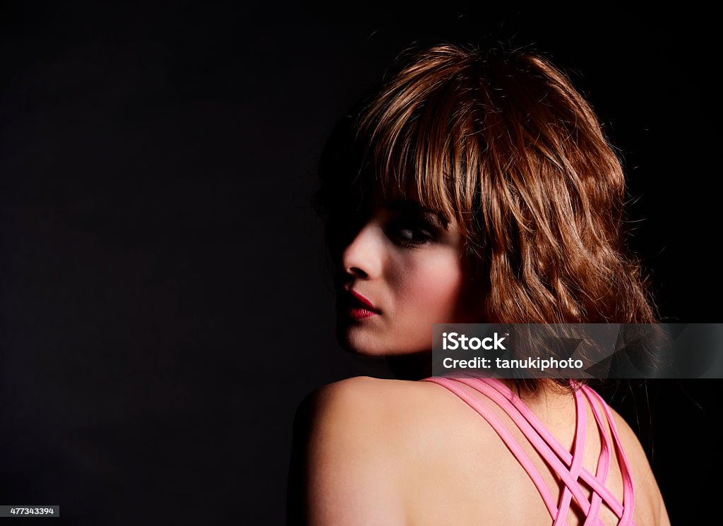 Brunette Woman Portrait Portrait of a beautiful caucasian young woman isolated on black. 2015 Stock Photo