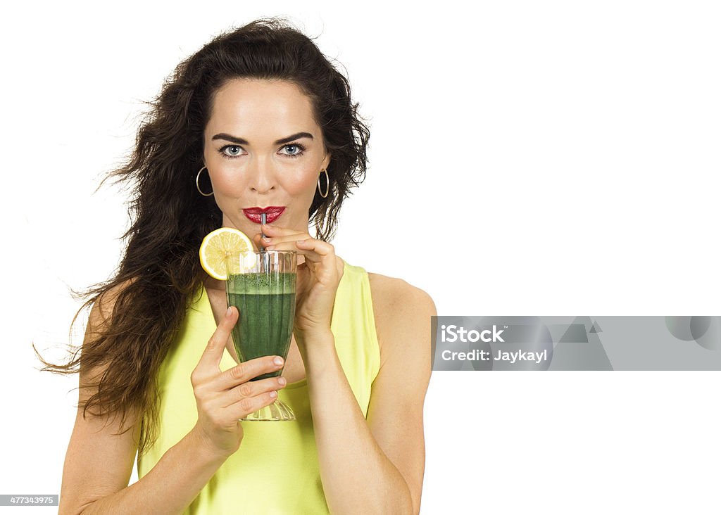 Woman drinking a green smoothie. Beautiful healthy woman drinking an organic green smoothie. Isolated on white. Drinking Stock Photo