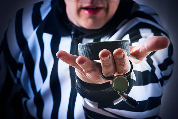 Hockey referee hold a puck Hockey referee hold a puck in his palm. Close view judge sports official stock pictures, royalty-free photos & images