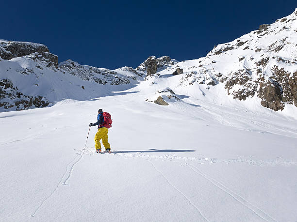 istock Skier walking up slope in powder snow 477346307