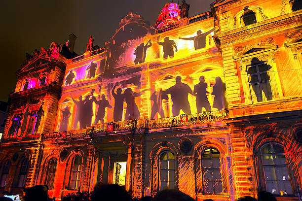 Lyon, France - December 6, 2014: street view with crowd of tourists and locals of Festival of Lights in Lyon, France. The origins of this festival, named Fete des Lumieres, date to 1643.