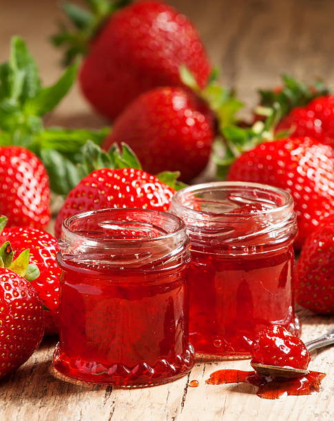 istock Fresh homemade strawberry jam with berries in small jars, select 477349552