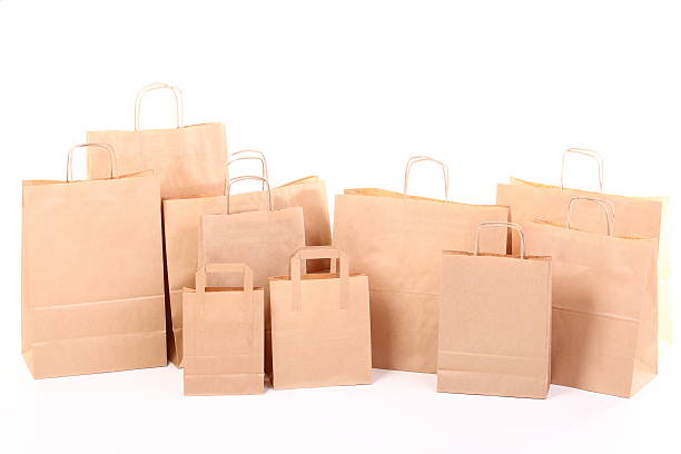 istock Shopping brown gift bags isolated 477350397