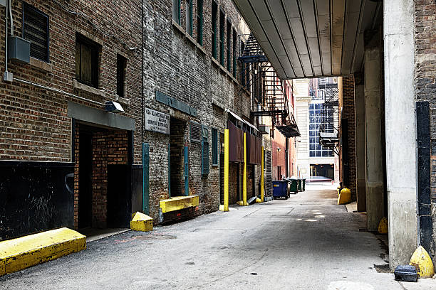 Chicago, USA - June 9, 2015: Service entrances in a back alley at 624 South Michigan Avenue in The Loop, downtown Chicago. Girl sitting on steps.