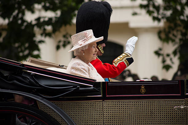 Queen Elizabeth II in an open carriage with Prince Philip London, England - June 13, 2015: Queen Elizabeth II in an open carriage with Prince Philip for trooping the colour 2015 to mark the Queens official birthday, London, UK royal person photos stock pictures, royalty-free photos & images