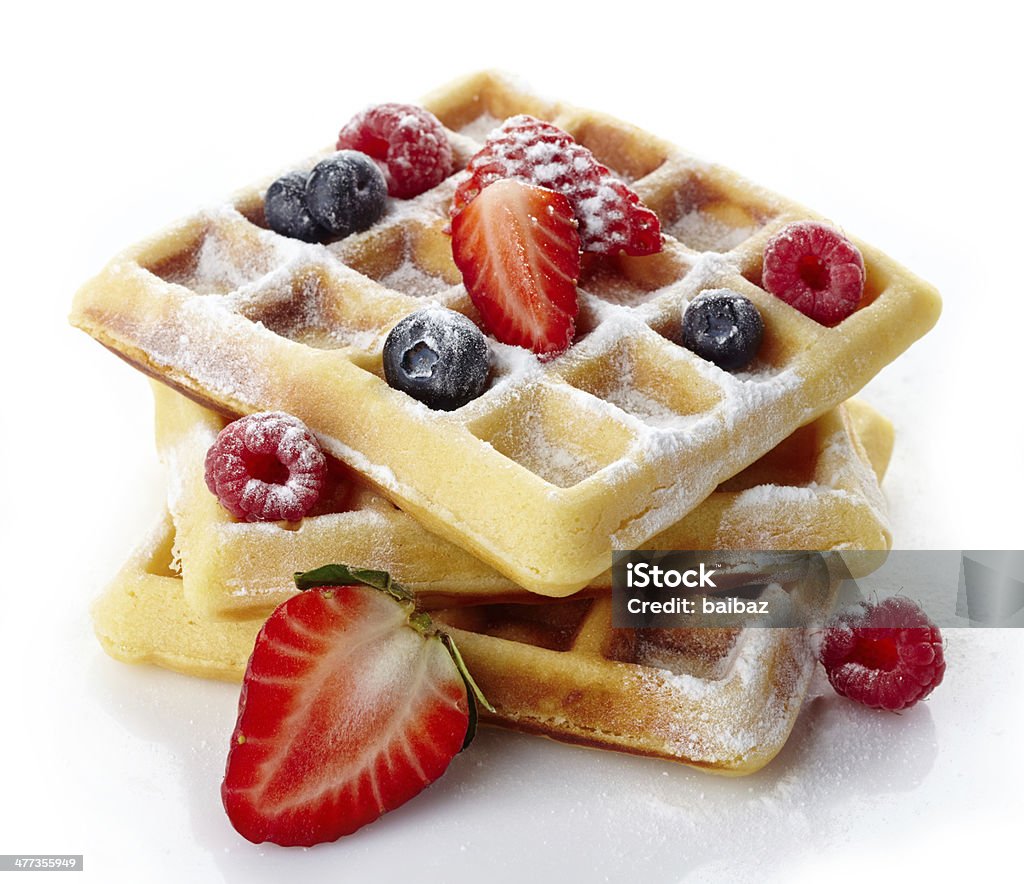 Belgium waffles Belgium waffles with fresh berries and caster sugar isolated on white background Waffle Stock Photo