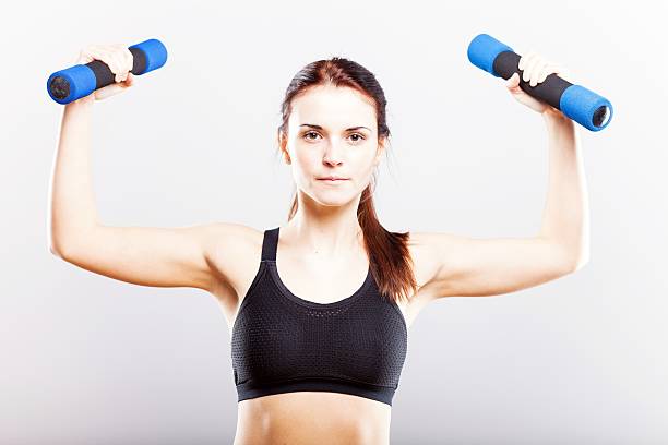 istock Young fit woman training with dumbbells 477356417