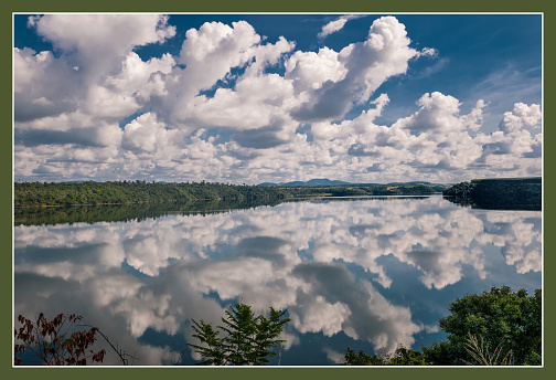 Cloud Reflections on a brazilian lake surrounded with a Rainforest