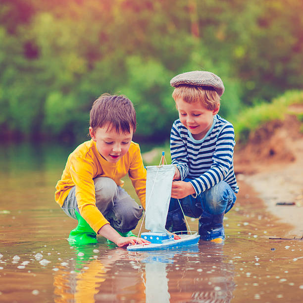 istock Children with toy ship 477356828