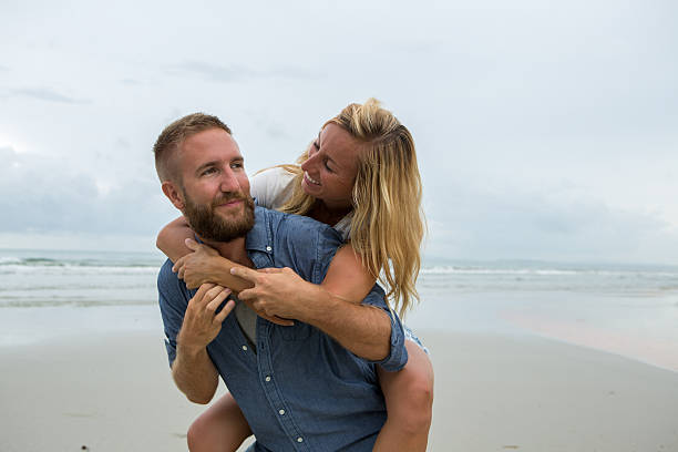 istock Young couple playing on the beach-Cloudy day 477357316