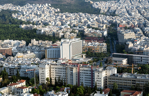 Aerial vertical photo of Athens Historical Center - Acropolis of Athens, Monastiraki, Thisio, Ancient Agora, pedestrian streets, parks, lycabetus hill and the hill of Filopappou - Greece, at dusk