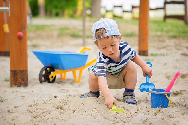 Little boy Young boy playing in the playground in summertime sandbox stock pictures, royalty-free photos & images