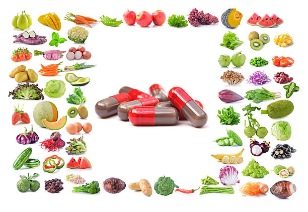 istock medical capsules,fruit and vegetable isolated on white backgroun 477365558