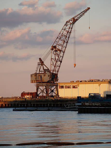 istock Rusted Grey Crane Harbor Against Cloudy Sky 477365570