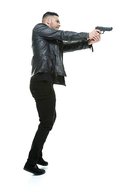istock Young man firing gun 477368496