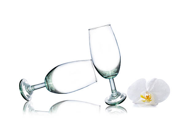 istock glass and White orchid isolated on white 477368696