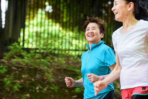 istock Senior women running in park 477368776