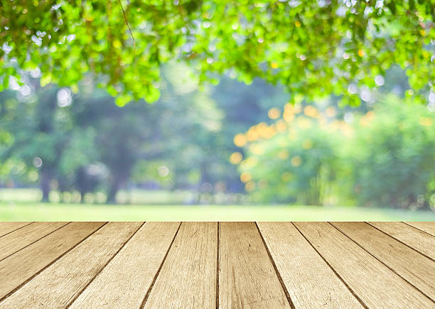istock Perspective wood over blur trees with bokeh background, spring a 477369240