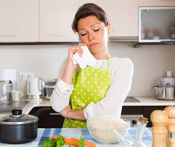 istock Sad woman cooking rice in the kitchen 477371862