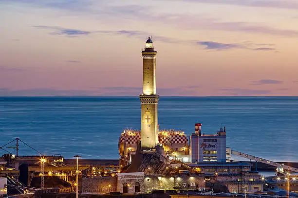 sunset in Genoa, Italy, with the city, the sea and lighthouse