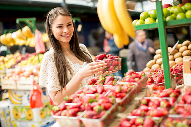 istock Young woman on the market 477372176