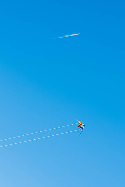 istock Jet liner and kite against bright blue sky 477372350